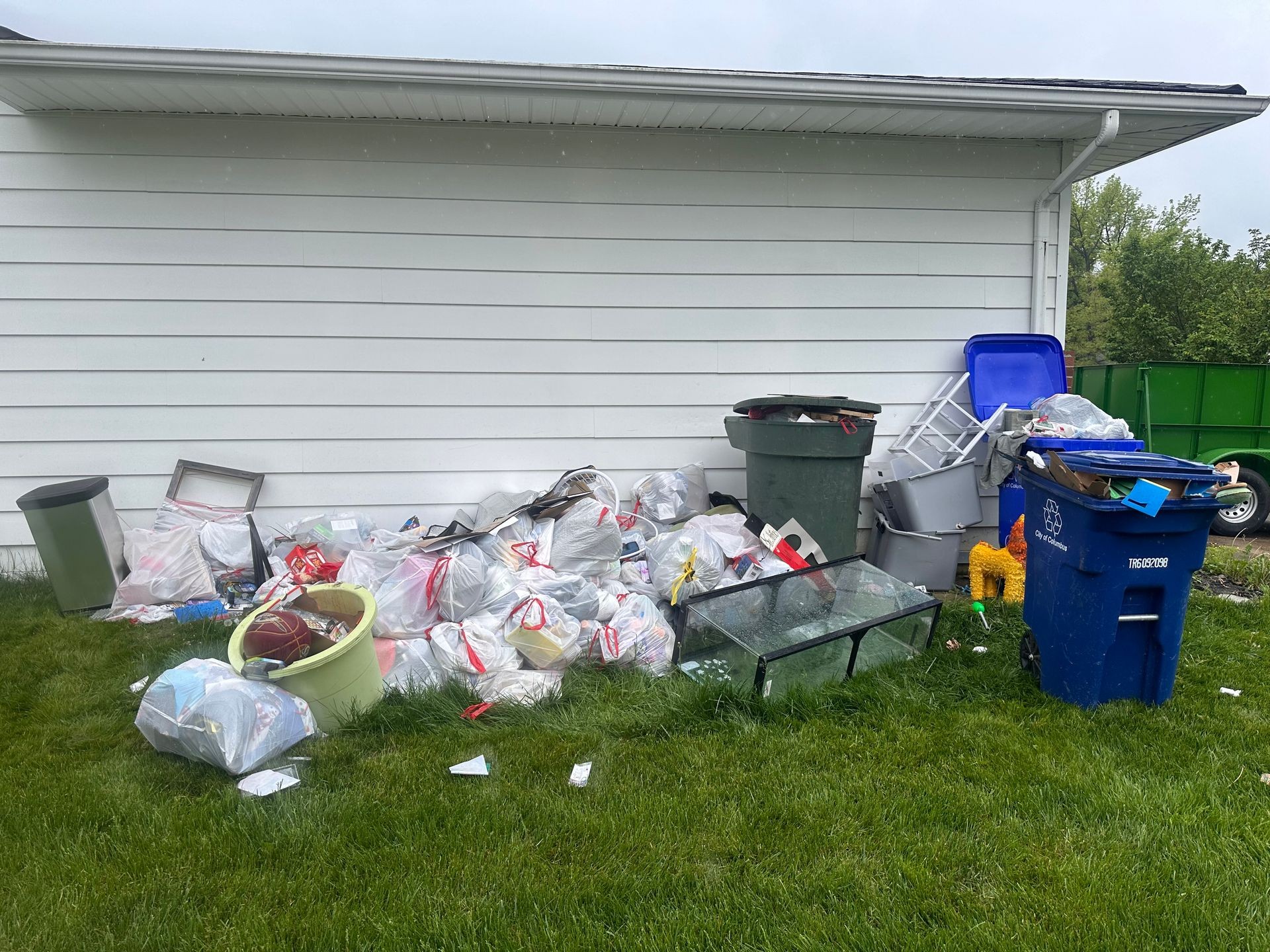 Junk on the side of the house that Shamrock Junk Removal cleaned up