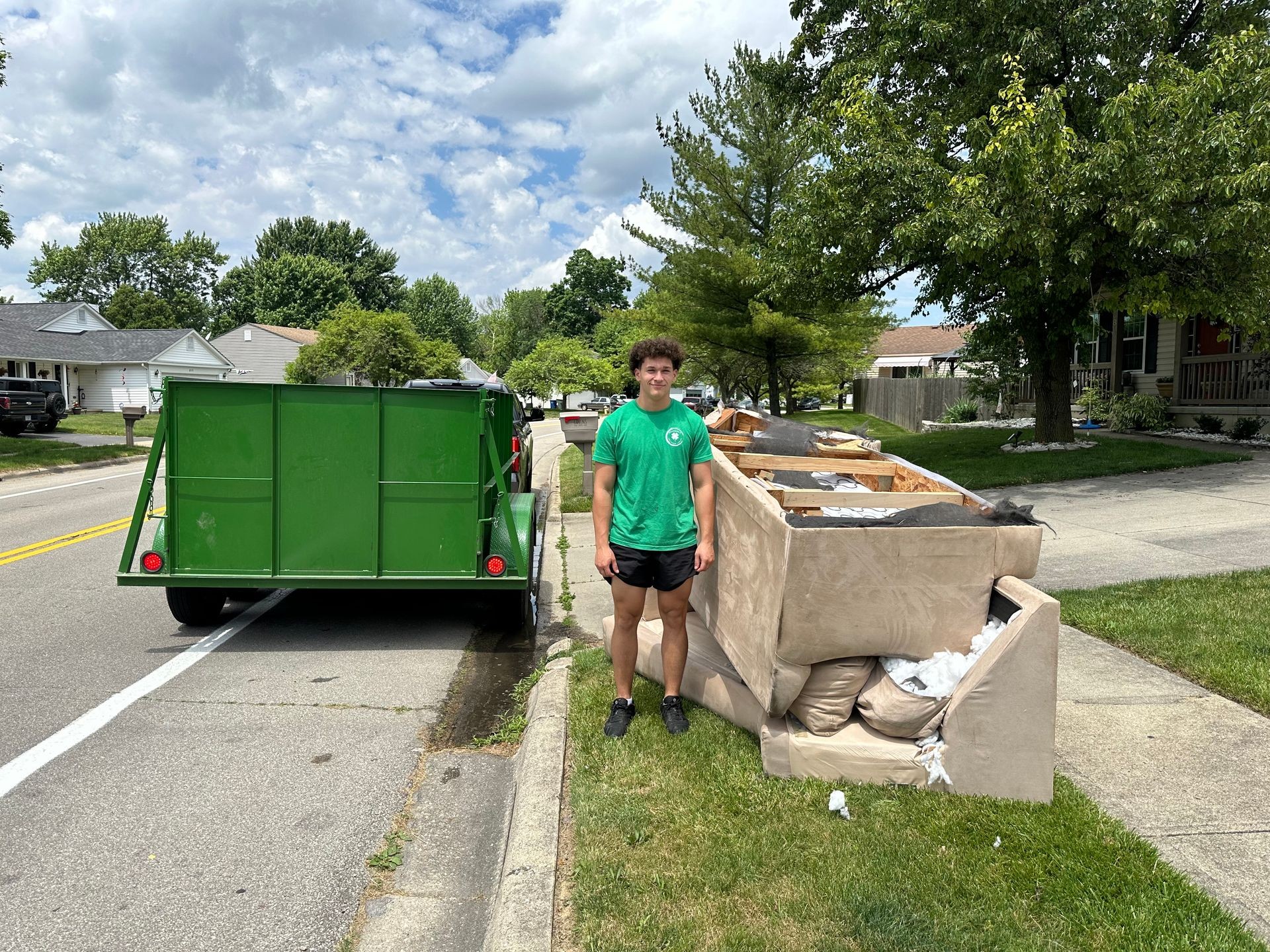 Shamrock Junk Removal removes a torn up couch for curb side pickup