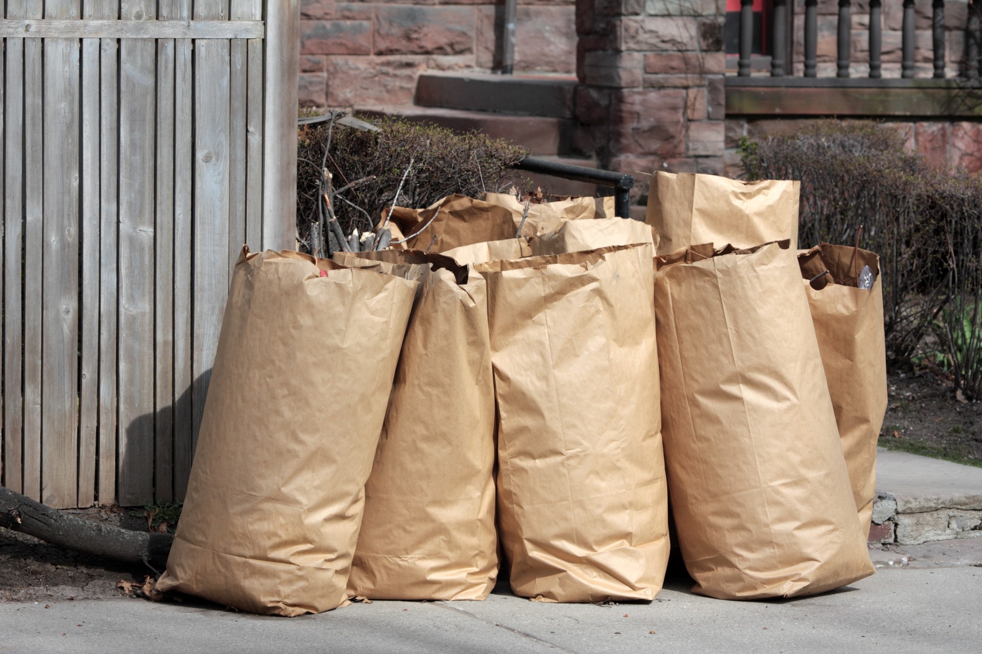 Shamrock Junk Removal removes yard waste from a curbside